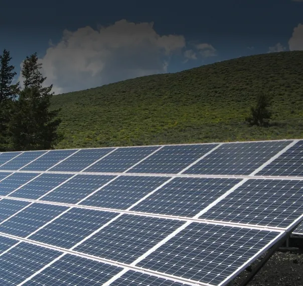 Array of solar panels on a grassy field.